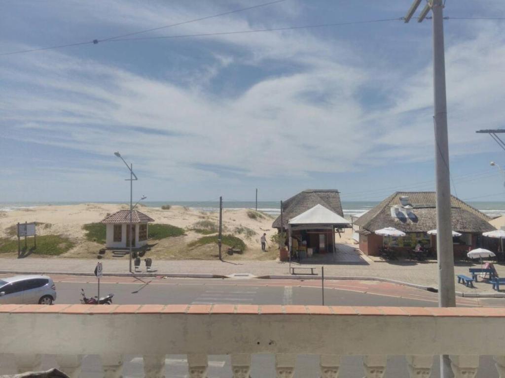 a view of a beach with buildings and the ocean at Apartamento Paraíso A Beira Mar in Torres