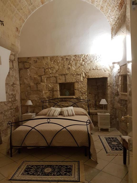A bed or beds in a room at La Dimora di Clary