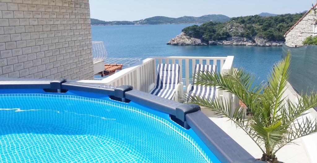 a swimming pool with a view of the water at Apartment Ela in Dubrovnik
