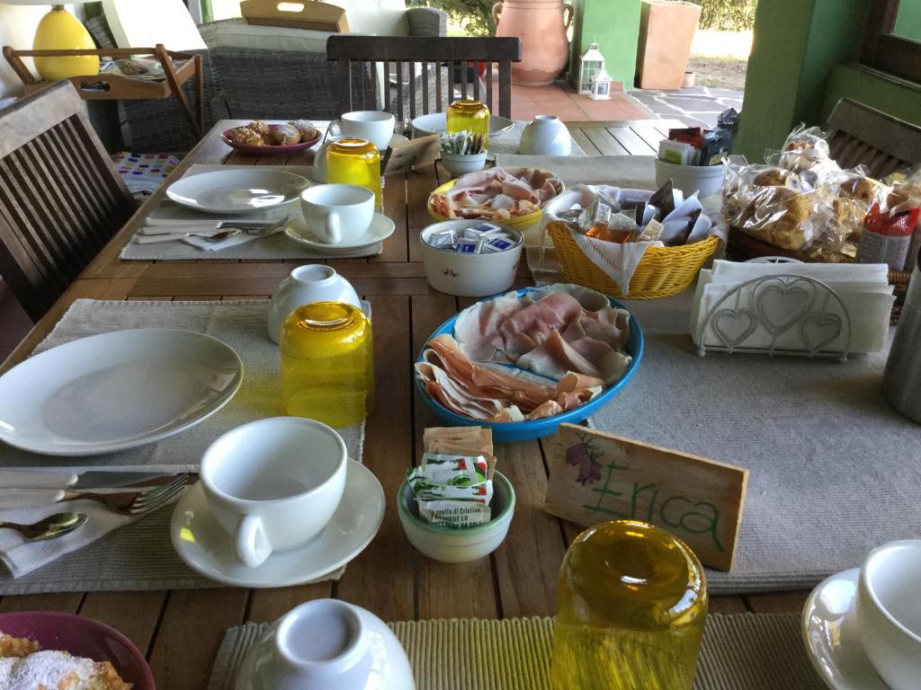 a table topped with plates and bowls of food at Villa Kuky in Santa Teresa Gallura