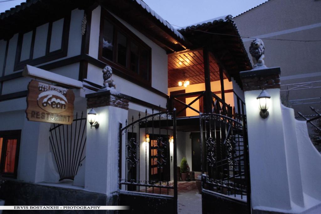 a building with a sign on the side of it at Guest House Bujtina Leon in Korçë