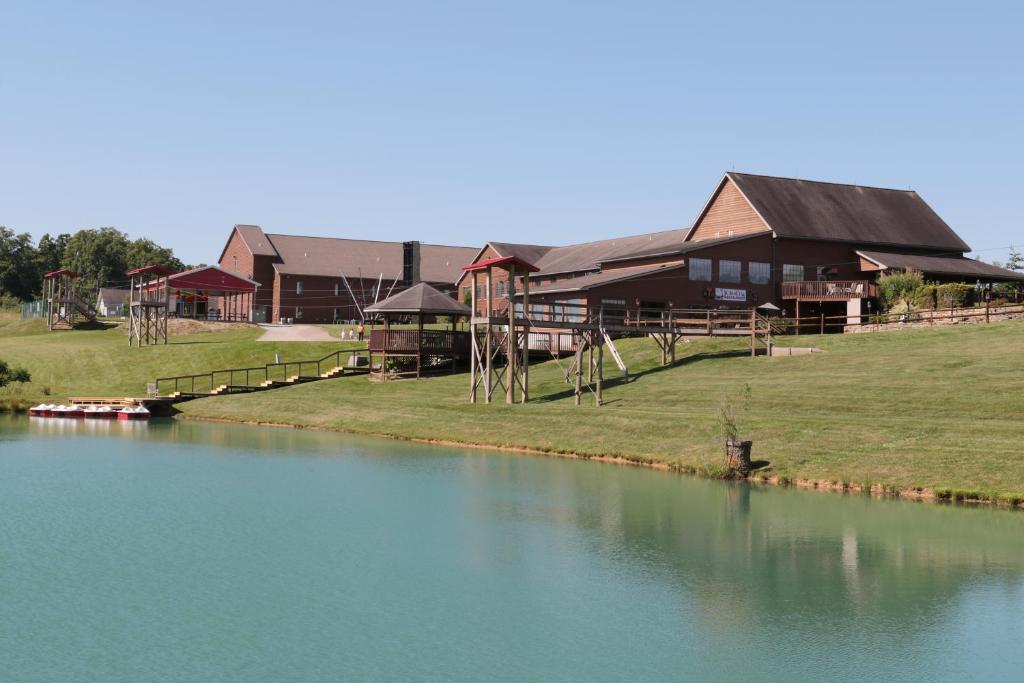 a house next to a body of water at Santa's Lodge in Santa Claus