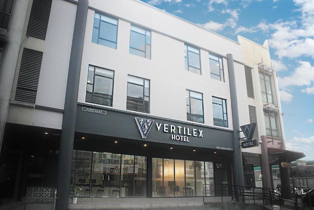a white building with a sign for a veridian hotel at Vertilex Hotel in Johor Bahru