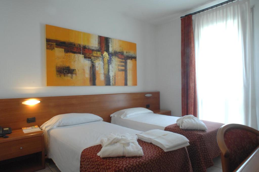 Postel nebo postele na pokoji v ubytování Hotel Scaldaferro