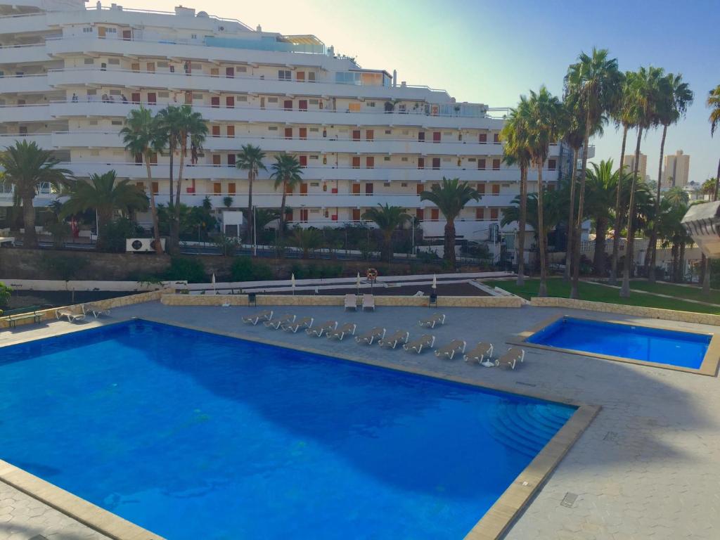 a large swimming pool in front of a large building at Apartment for 4 person! Viña del mar in Playa de las Americas
