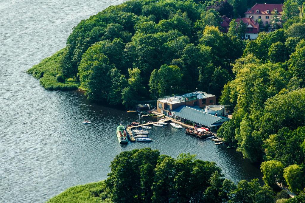 an aerial view of a dock on a lake with boats at Hotel Active in Szczecinek