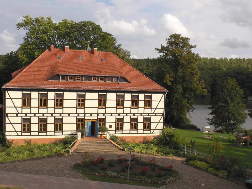 a large white building with a red roof at Drostenhaus Feldberg in Feldberg