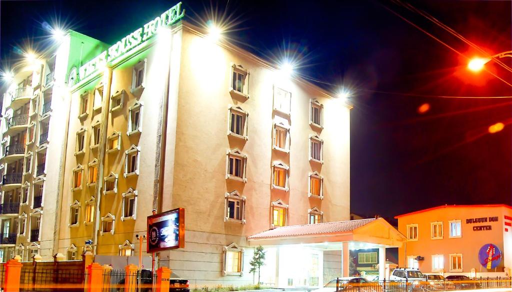 a hotel building with a sign on the side of it at White House Hotel in Ulaanbaatar