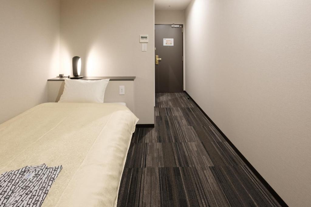 Postel nebo postele na pokoji v ubytování The Premium Hotel In Rinku