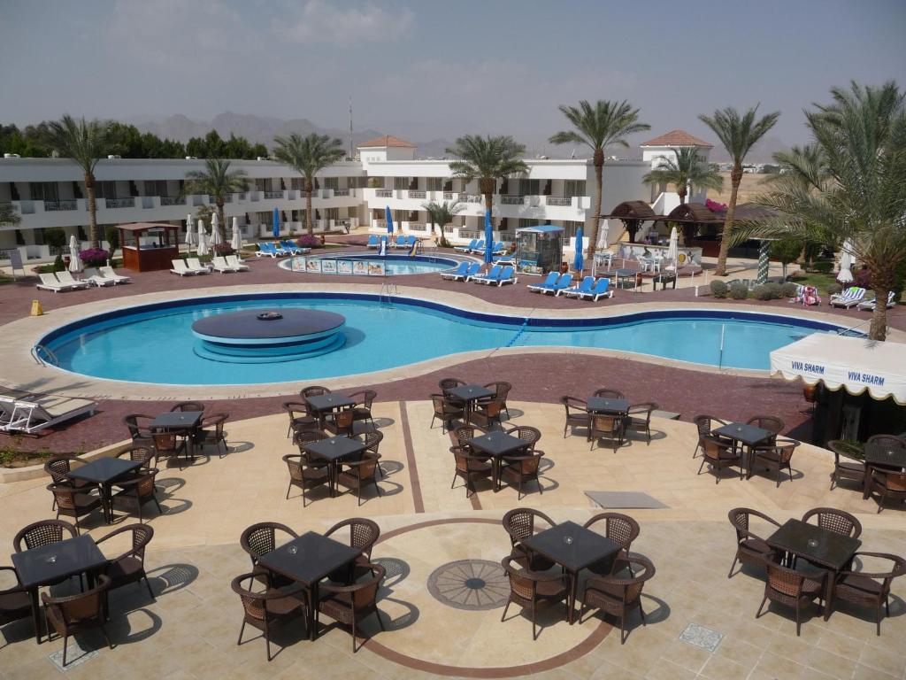 an overhead view of a pool with tables and chairs at Viva Sharm in Sharm El Sheikh