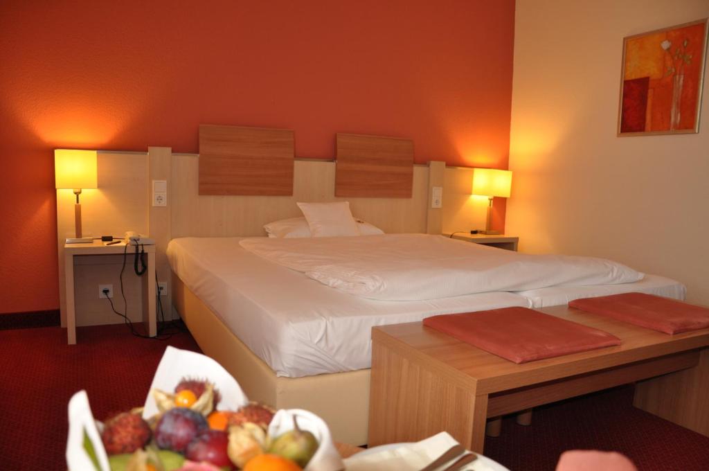 Postel nebo postele na pokoji v ubytování Hotel am Kurpark