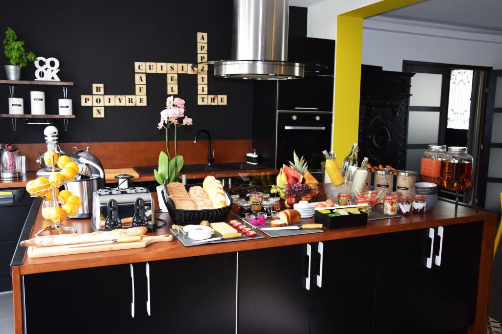 a buffet of food on a counter in a kitchen at Mont B&B in Pontorson