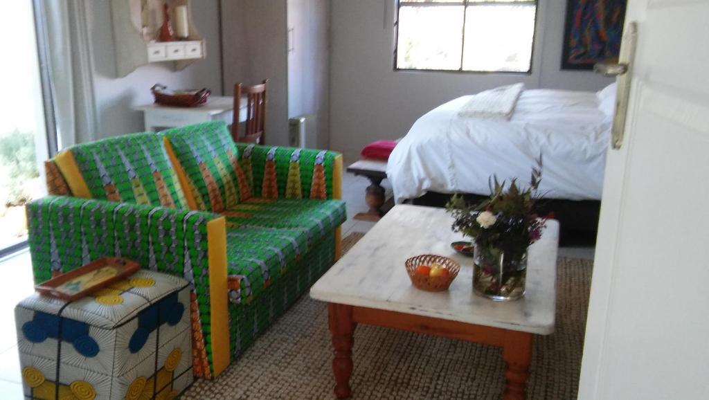 a living room with a couch and a bed at @Home Cottage in Johannesburg