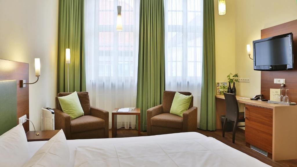 Postel nebo postele na pokoji v ubytování Altstadthof Freinsheim