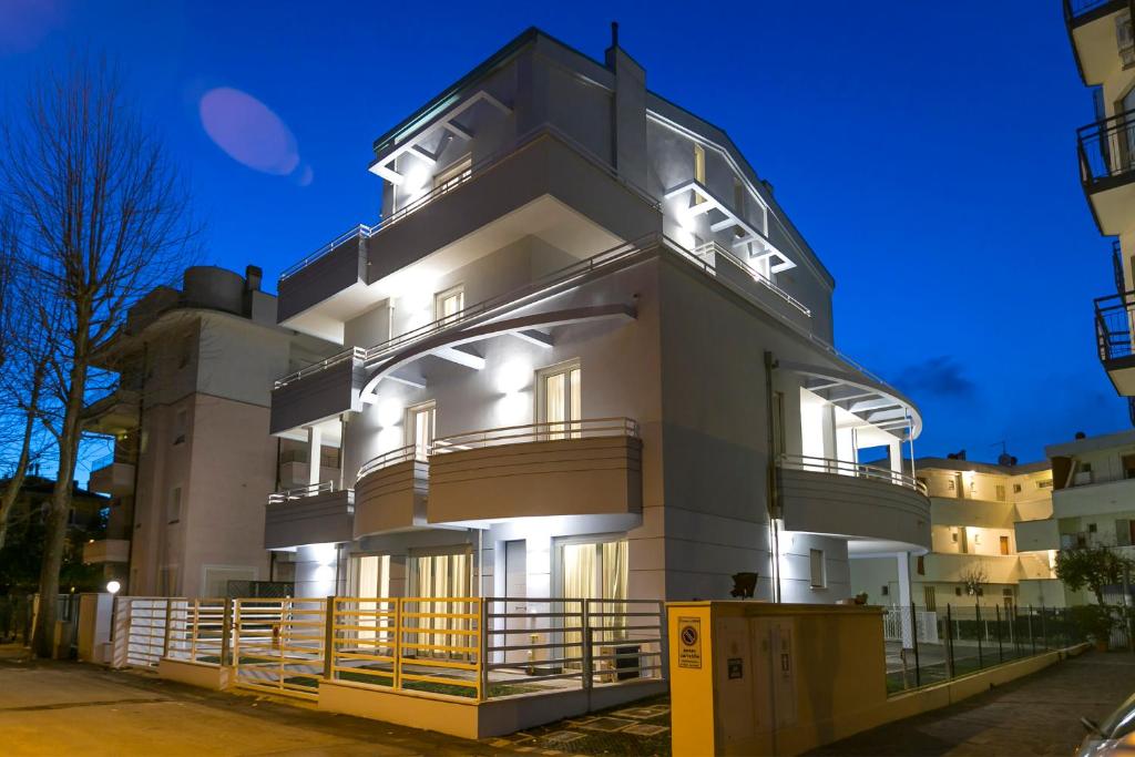 a large building with lights on the side of it at Residenza Riva Azzurra in Rimini
