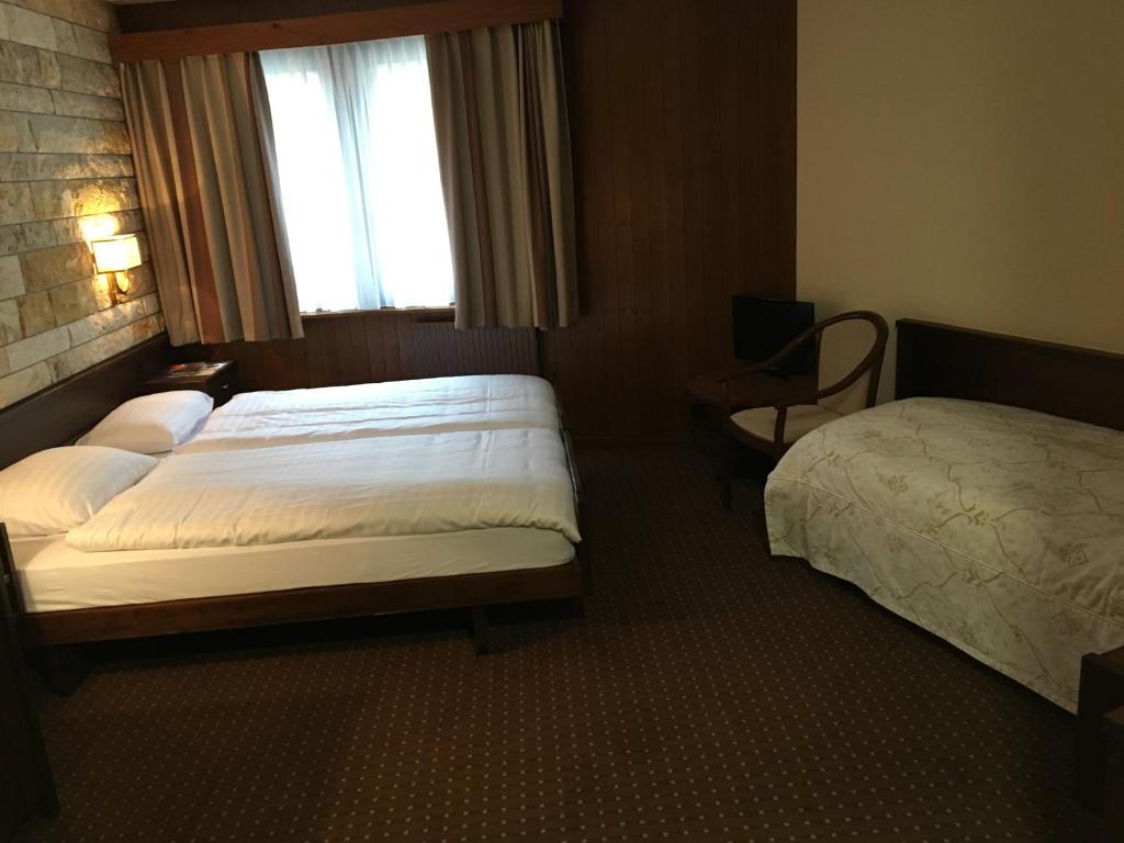 Postel nebo postele na pokoji v ubytování Hotel Restaurant La Porte d'Octodure