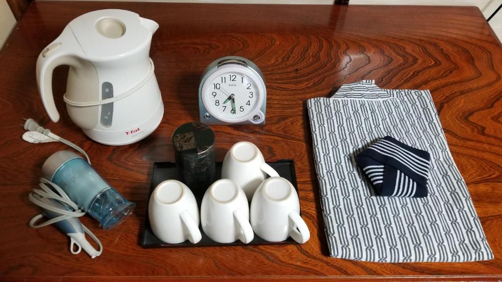 a table with a clock and some items on it at Ryokan Katsutaro in Tokyo