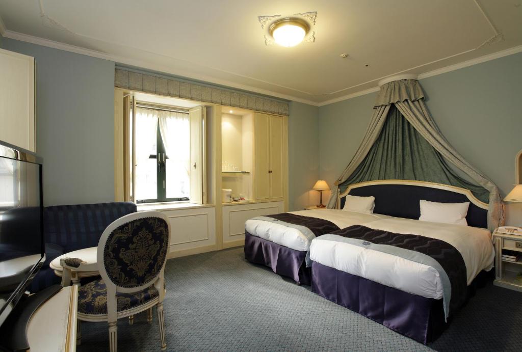 Postel nebo postele na pokoji v ubytování Hotel Monterey Osaka