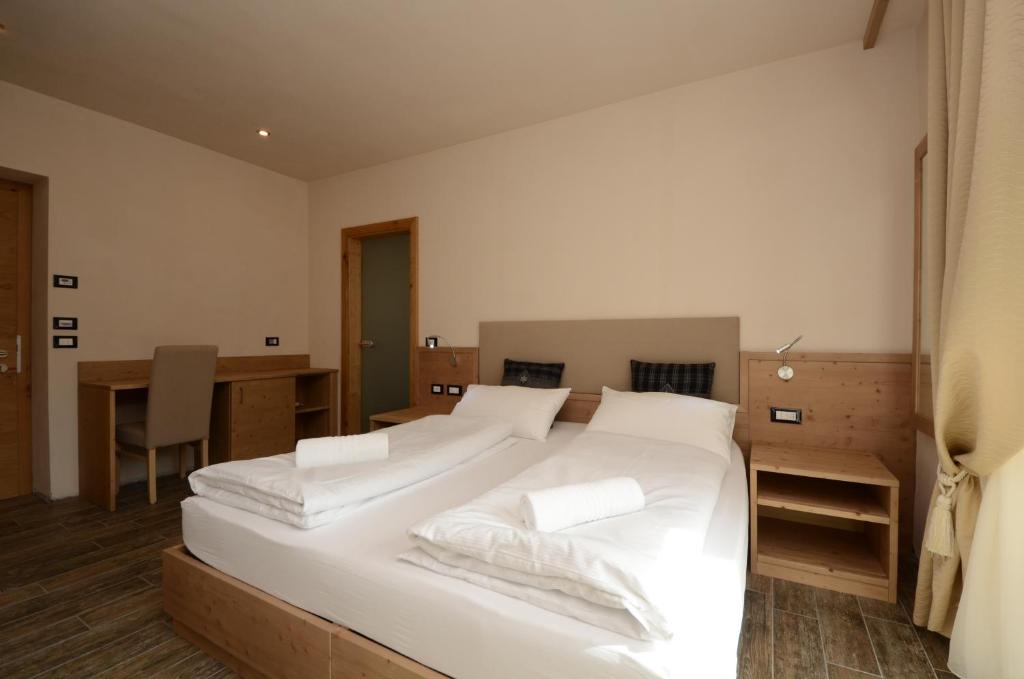 Postel nebo postele na pokoji v ubytování Park Hotel Avisio