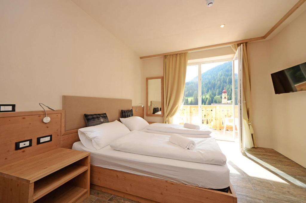 Postel nebo postele na pokoji v ubytování Park Hotel Avisio