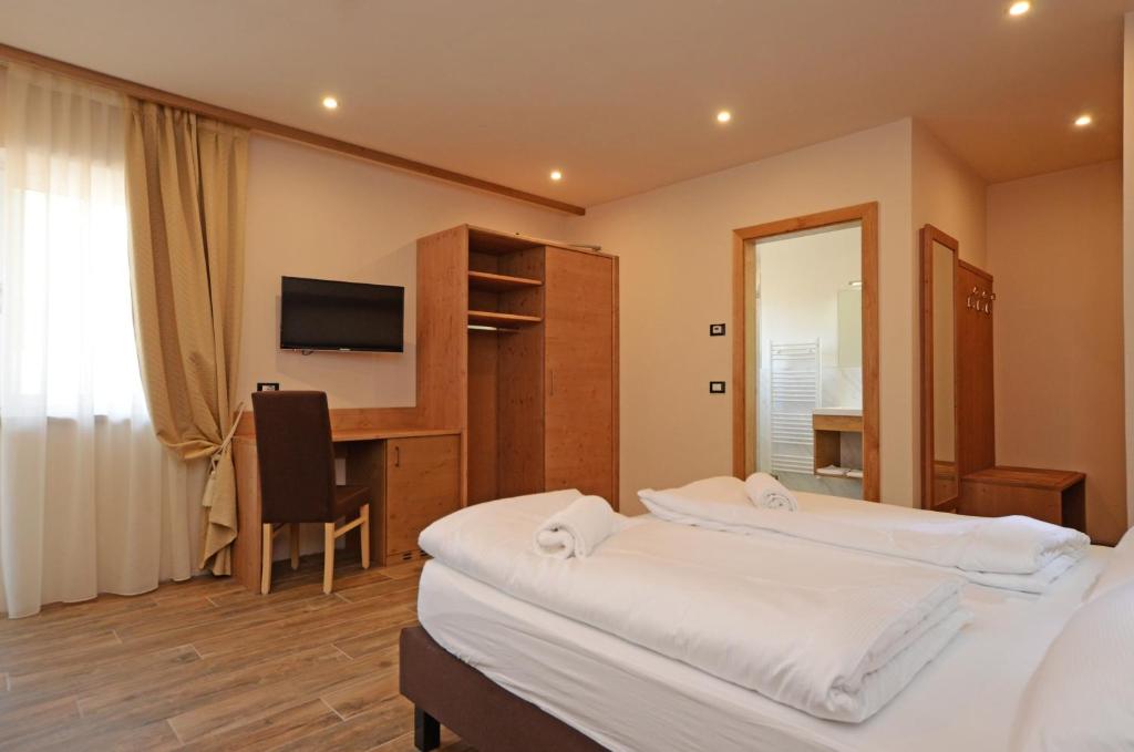 Postel nebo postele na pokoji v ubytování Park Hotel Avisio