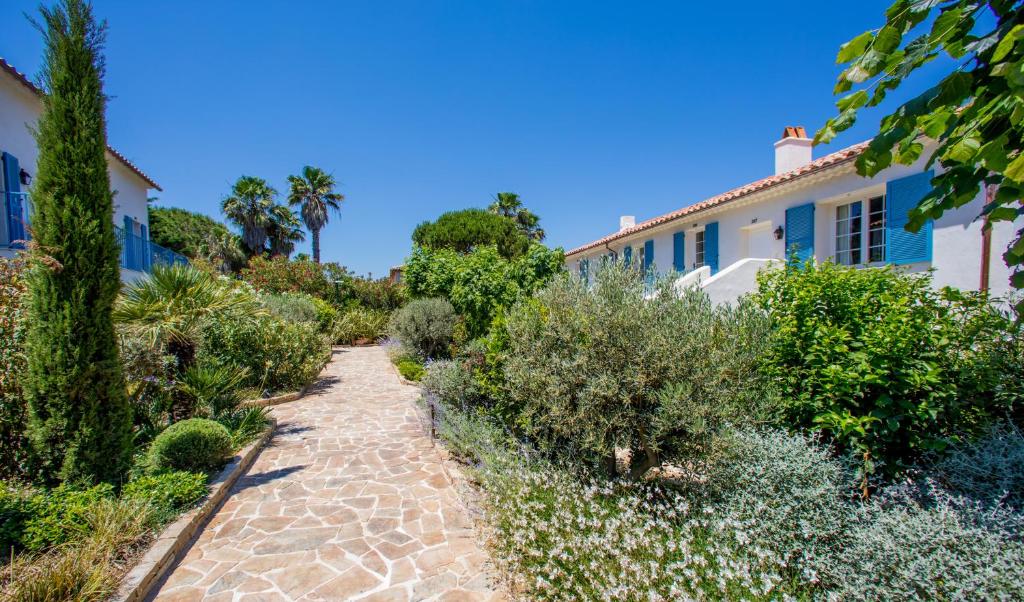 a garden in front of a house at La Bastide des Salins in Saint-Tropez