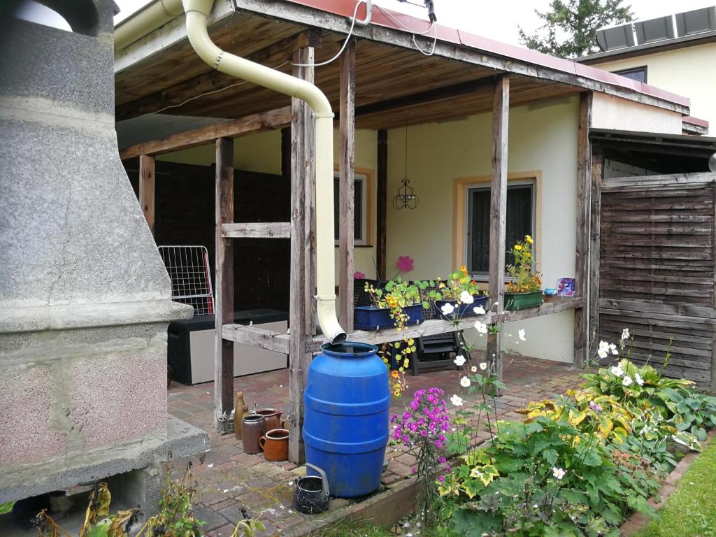 a large blue barrel sitting outside of a house at Ferienwohnung-gurran in Lübben