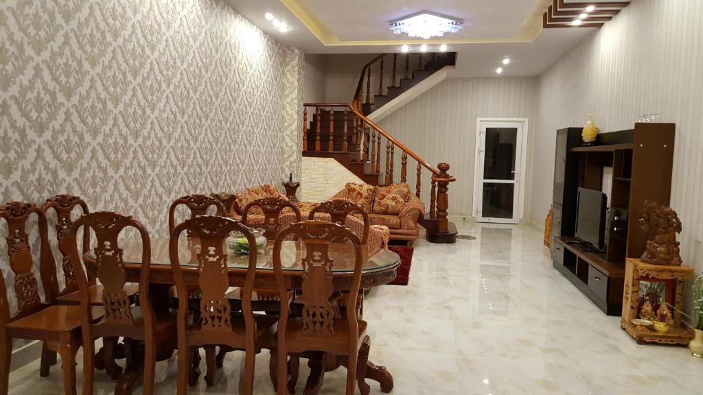 uma sala de jantar com uma mesa e um sofá em Căn hộ Cherry House Đà Lạt em Da Lat