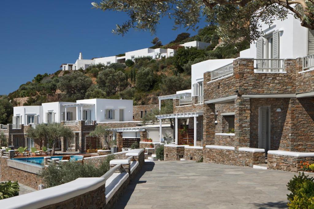 a view of a villa with a hill in the background at Selana Suites in Chrisopigi