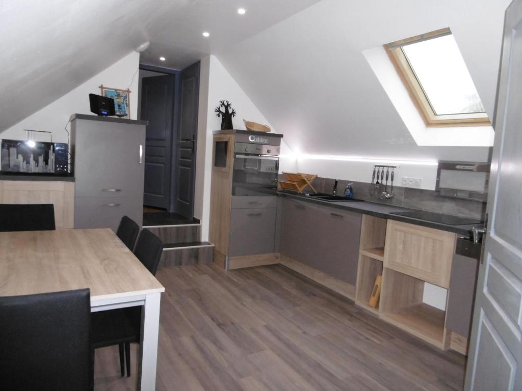 a kitchen with a sink and a counter top at Le petit domaine des Aubuis in Chinon