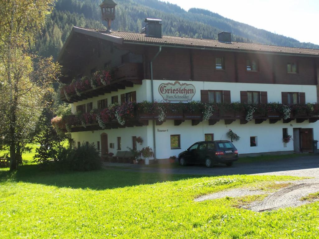 a building with a car parked in front of it at Bauernhof Grieslehen in Leogang