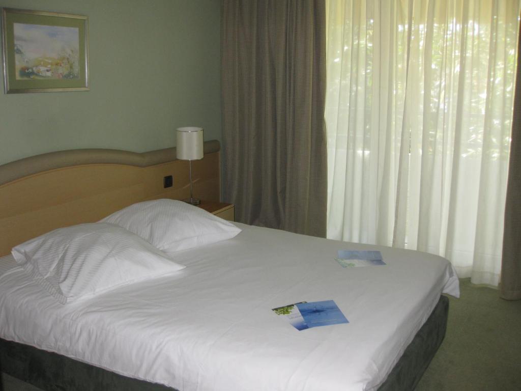 Postel nebo postele na pokoji v ubytování Hotel Kimen