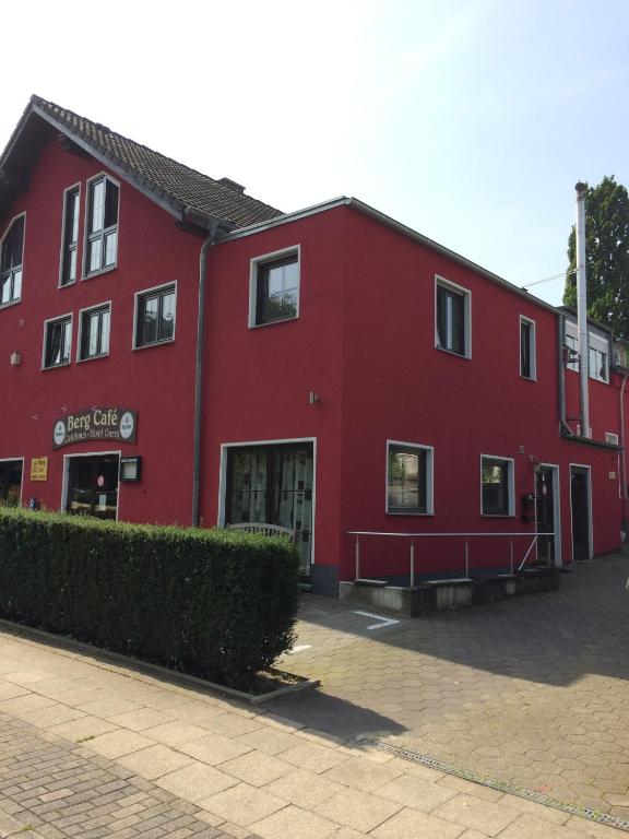 a red building with the front of it at Bergcafè - Hotel Kammann in Essen