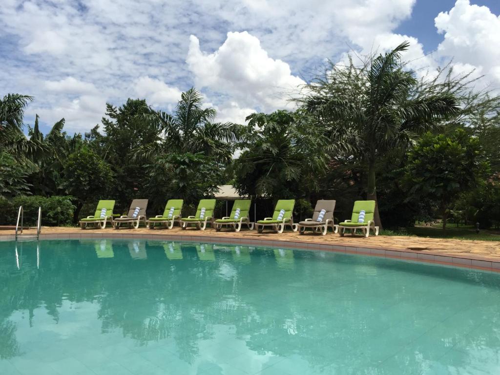 a group of chairs and a swimming pool at Arusha Planet Lodge in Arusha