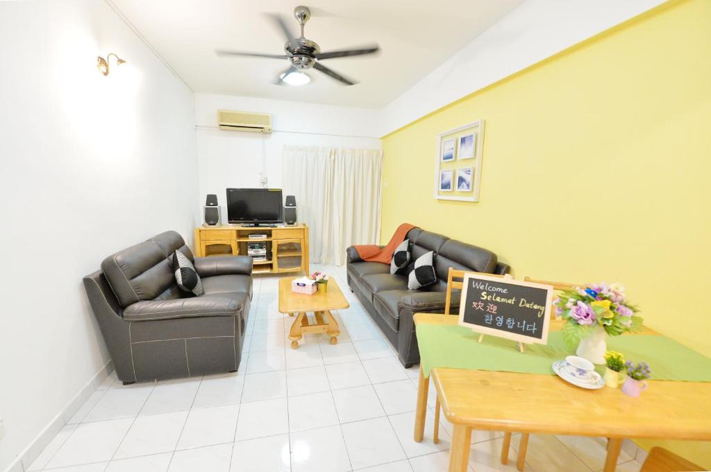 a living room with two couches and a tv at Kijal Family Apartment in Kijal