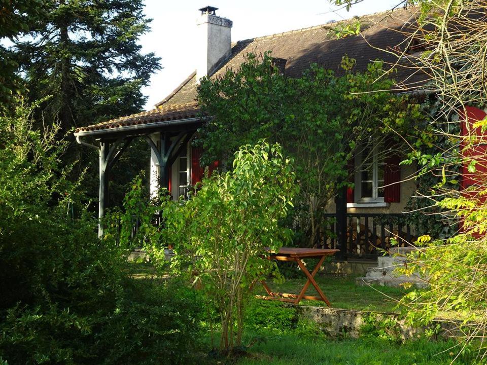 una casa con una mesa de picnic delante de ella en B&B Les Quatre Vents, en Montpon-Ménestérol