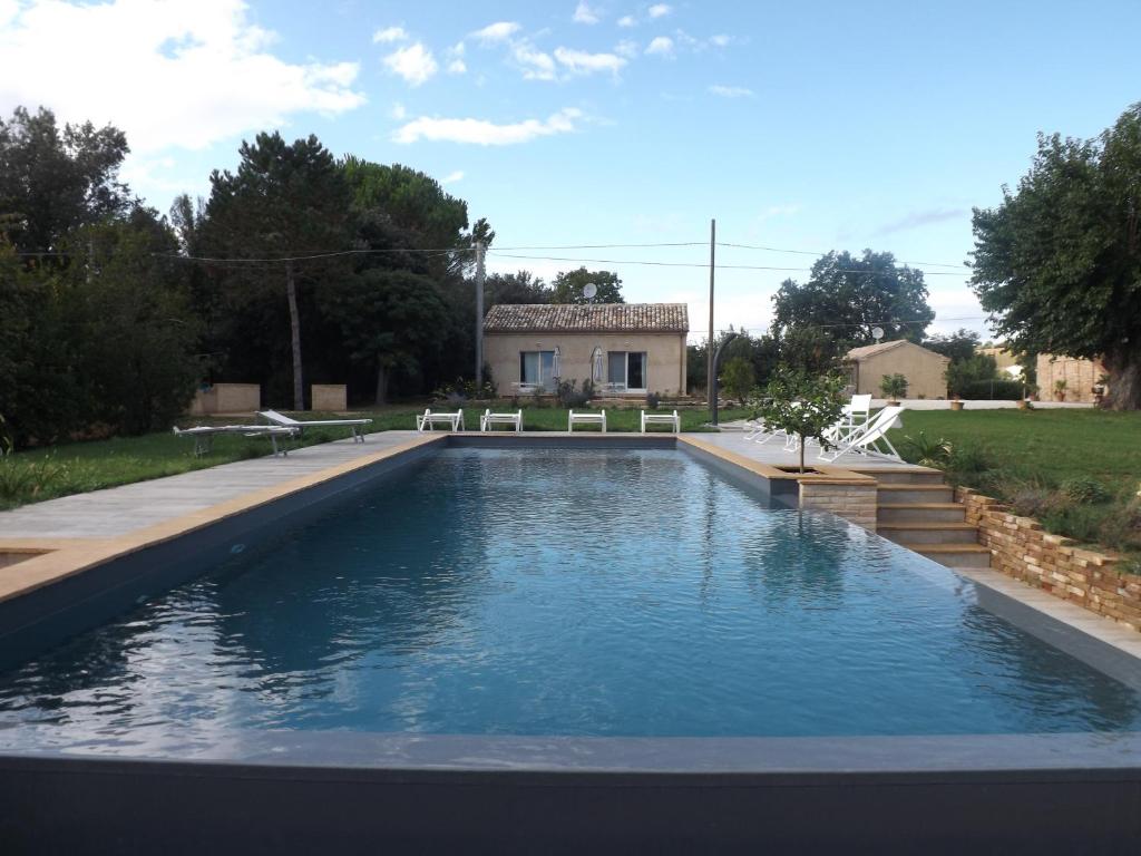 a swimming pool in a yard with a house at Tenuta del Viandante in Filottrano