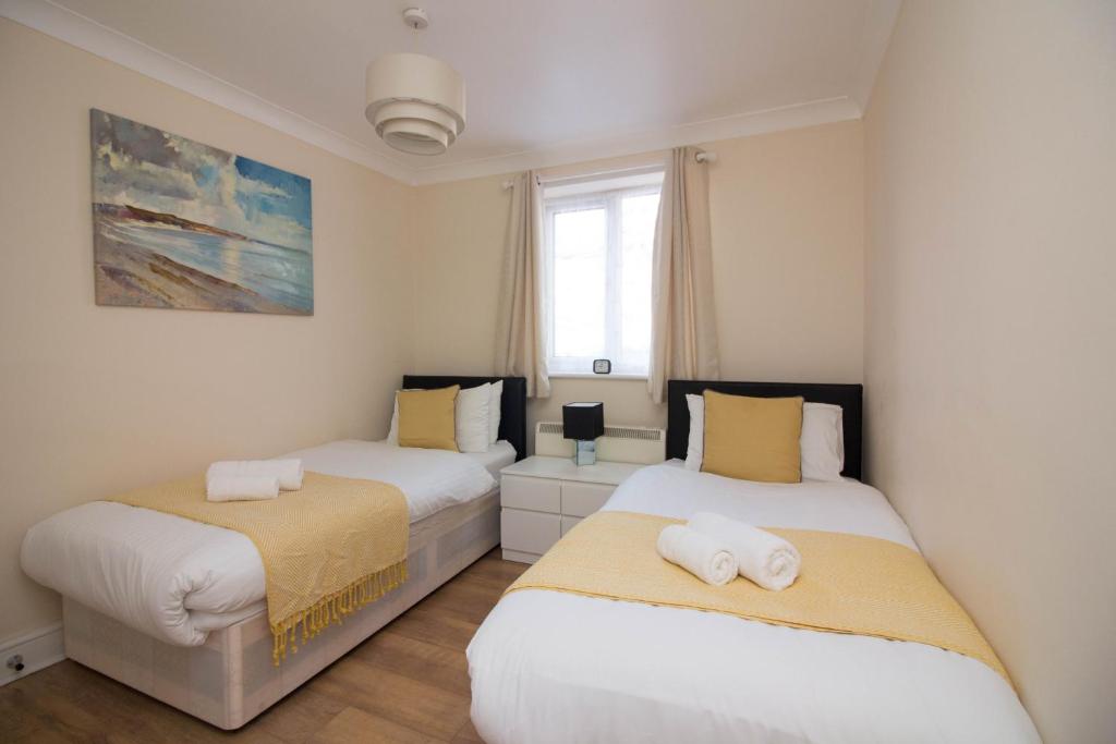 a bedroom with two beds and a window at StayZo Penthouse Accommodation 1- Premier Lodge in Southampton