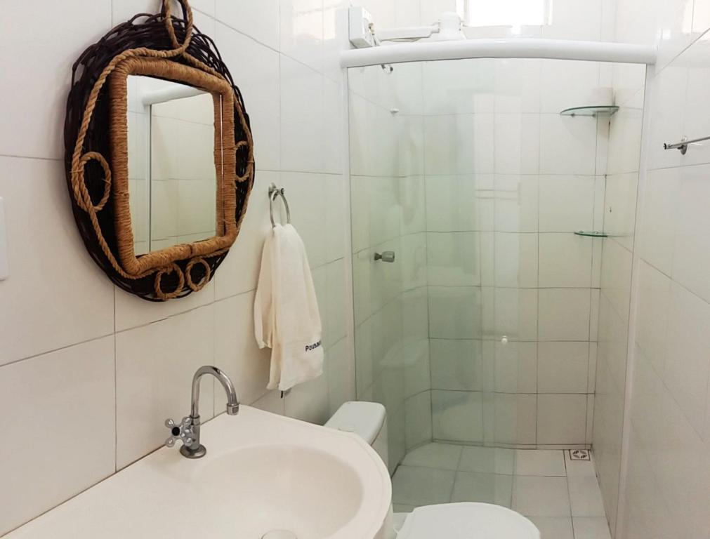 a bathroom with a sink and a shower at Pousada Beira Rio Parnaíba in Parnaíba