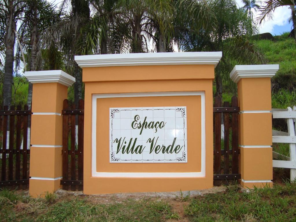 een oranje hek met een welkomstbord erop bij Espaço Villa Verde in Socorro