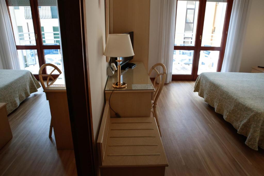Ein Bett oder Betten in einem Zimmer der Unterkunft Hotel Croce Di Malta