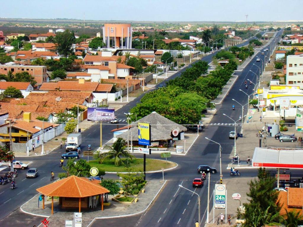 a street in a town with cars on the road at Pousada Beira Rio Parnaíba in Parnaíba
