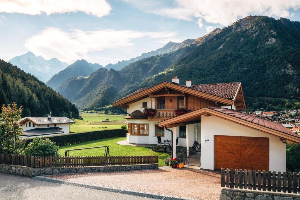 a house with mountains in the background at Haus Waldblick Pfunds in Pfunds