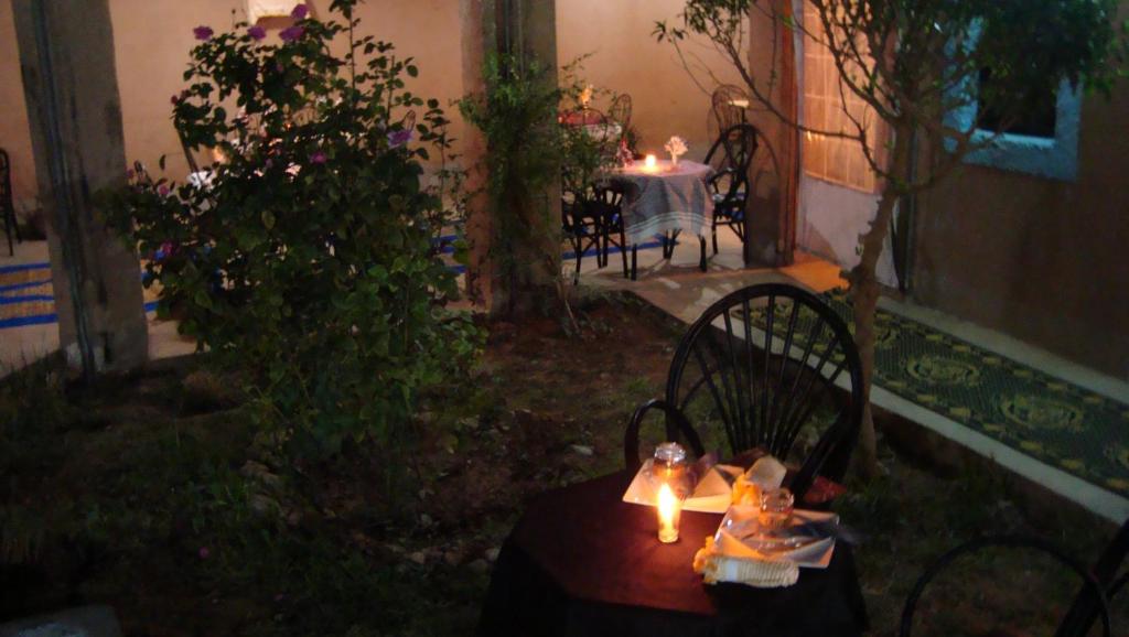 una mesa con una vela en un patio en Auberge Toda, en Aït Igad