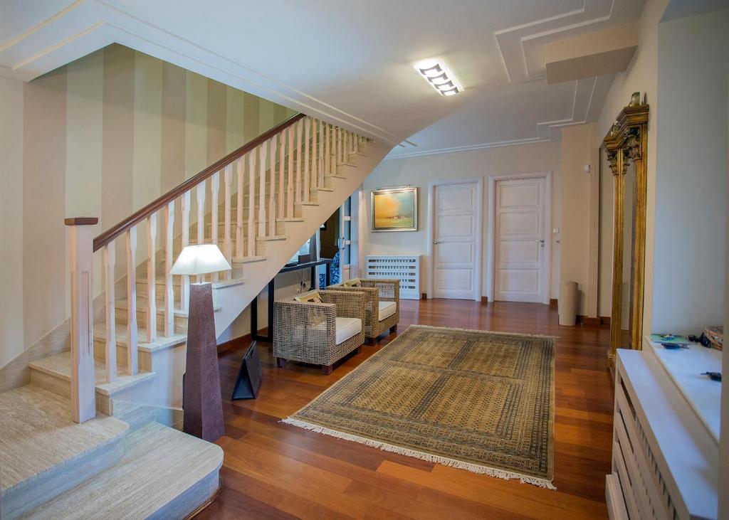 a living room with a staircase and a rug at La Alberca in Palencia