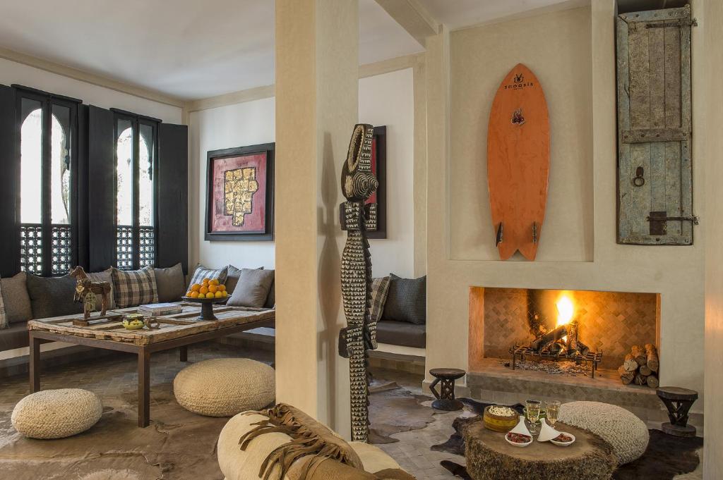 a living room with a surfboard hanging on the wall at Munga Guesthouse in Taghazout