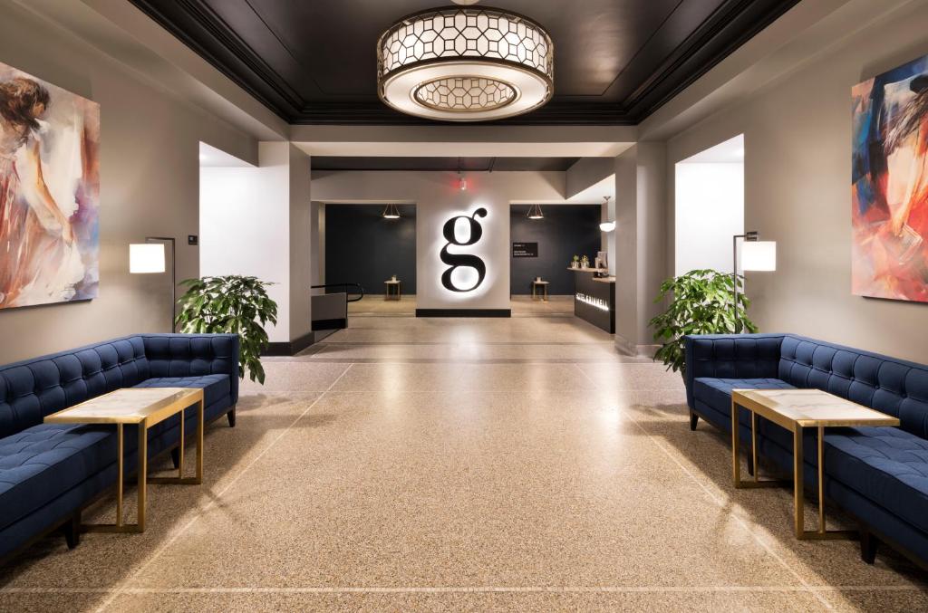 a lobby with blue couches and a number eight sign at Hotel Grinnell in Grinnell