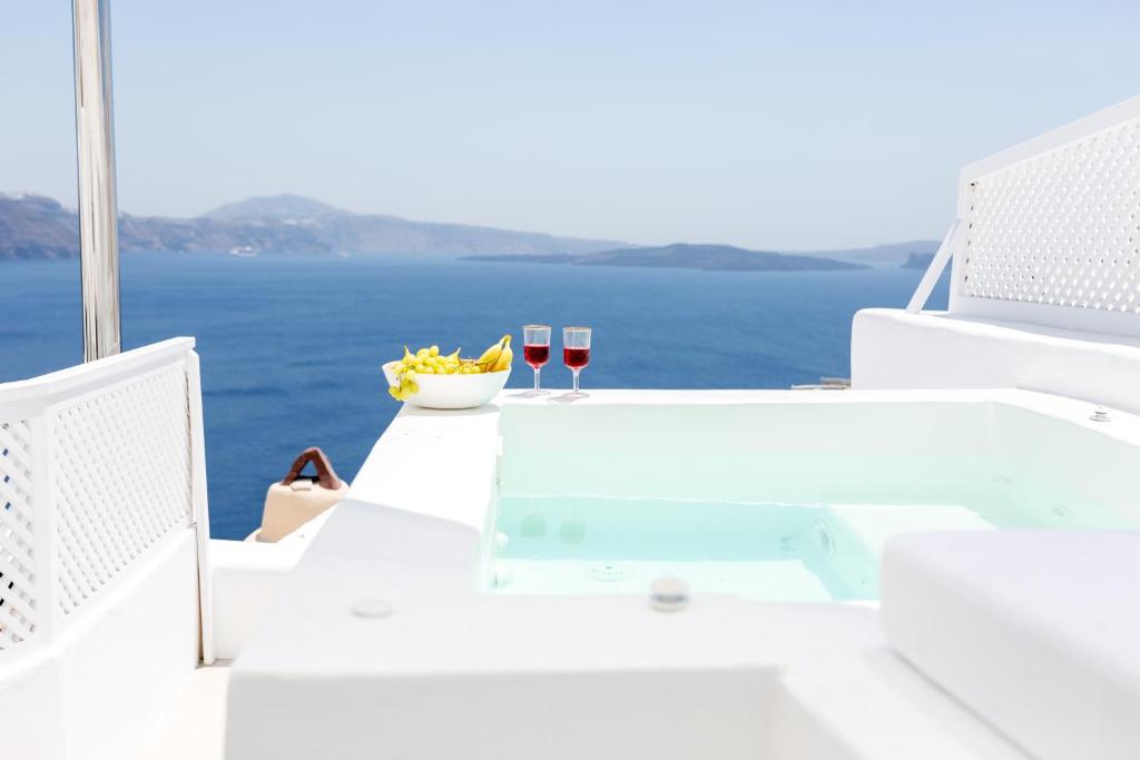 a blue and white surfboard sitting on top of a white boat at Delta Suites in Oia