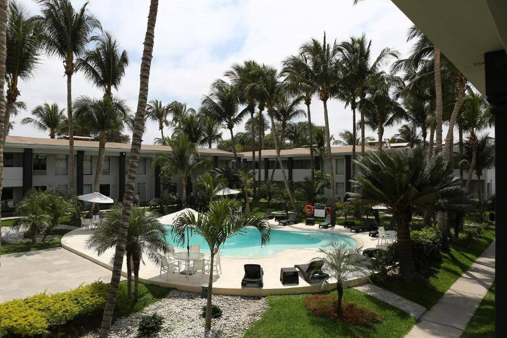 a view of a resort with a pool and palm trees at Casa Andina Premium Piura in Piura