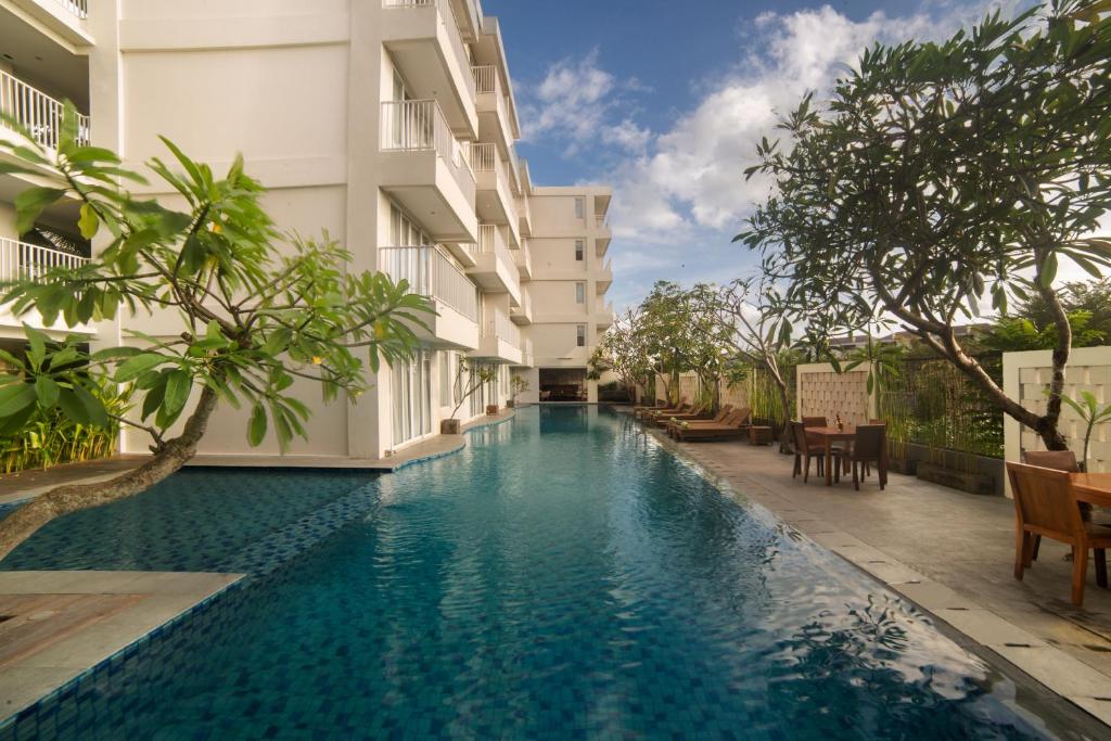 a swimming pool in the middle of a building at Paragon Hotel Seminyak in Seminyak